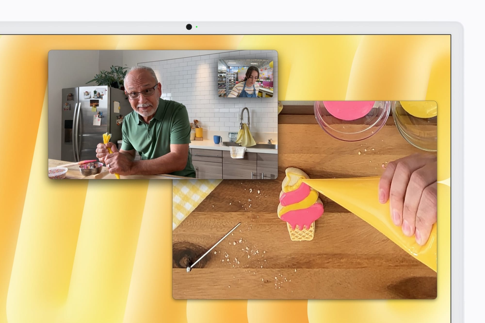 A FaceTime call on iMac with Desk View showing a cookie being decorated on a countertop