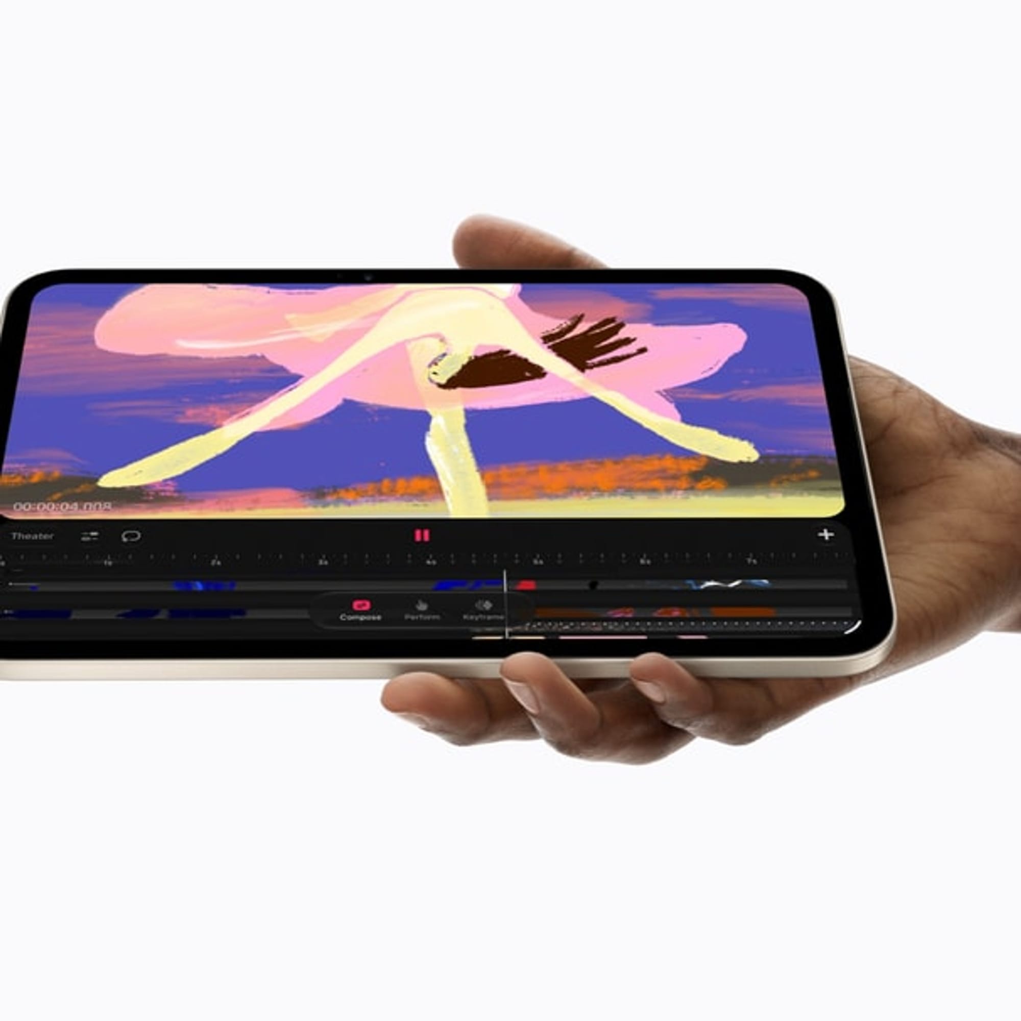 iPad mini held in one hand running Procreate Dreams