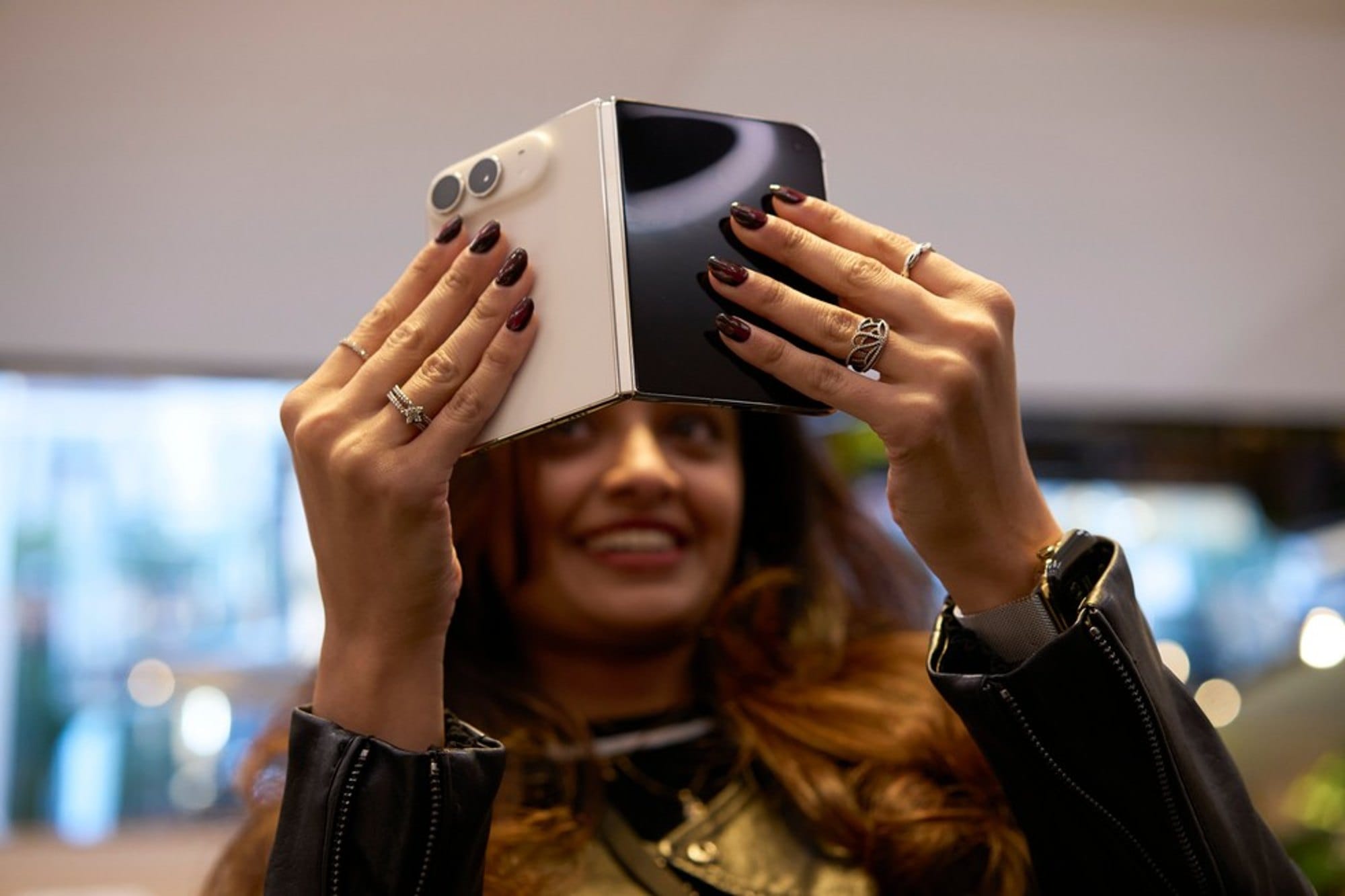 Close up of a customer holding a partly folded iPhone Duo