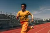 A runner wearing Apple Watch Series 12 sprints on a track
