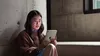 A person sitting by a window reading on the new iPad mini