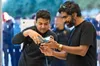 Two customers try the iPhone Duo hinge at an Apple Store display table