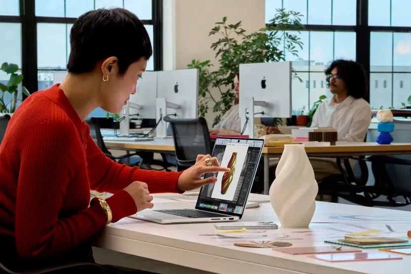 A person touching the PROLED XDR display on the new MacBook Pro