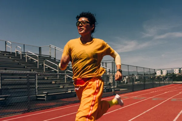 A runner wearing Apple Watch Series 12 sprints on a track